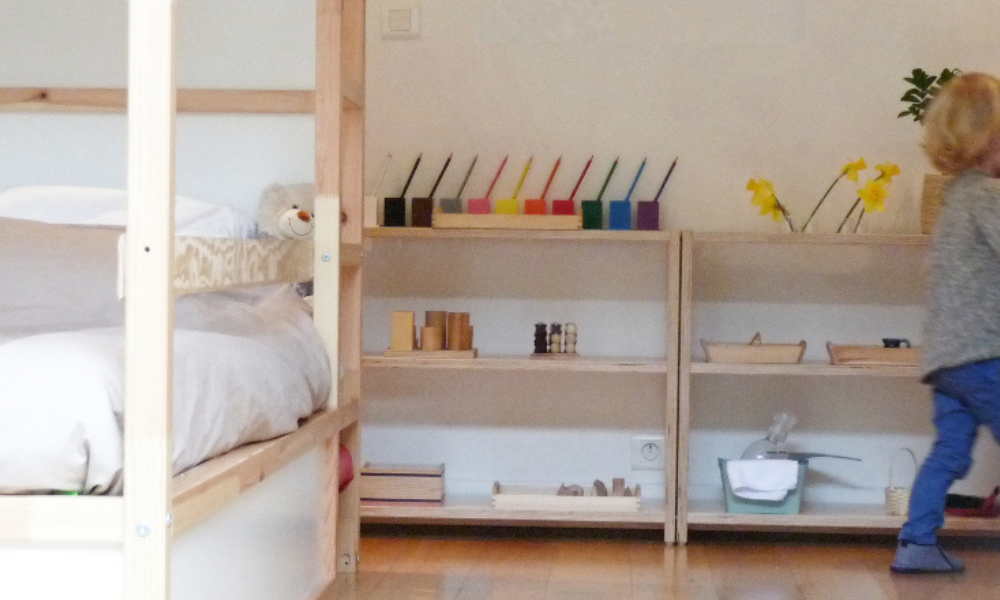 Chambre Montessori aérée avec lit bas, étagères accessibles et sélection de jouets éducatifs pour l'autonomie des enfants